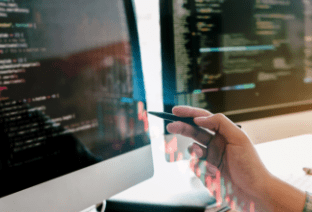 PCのモニターを指差しているところ